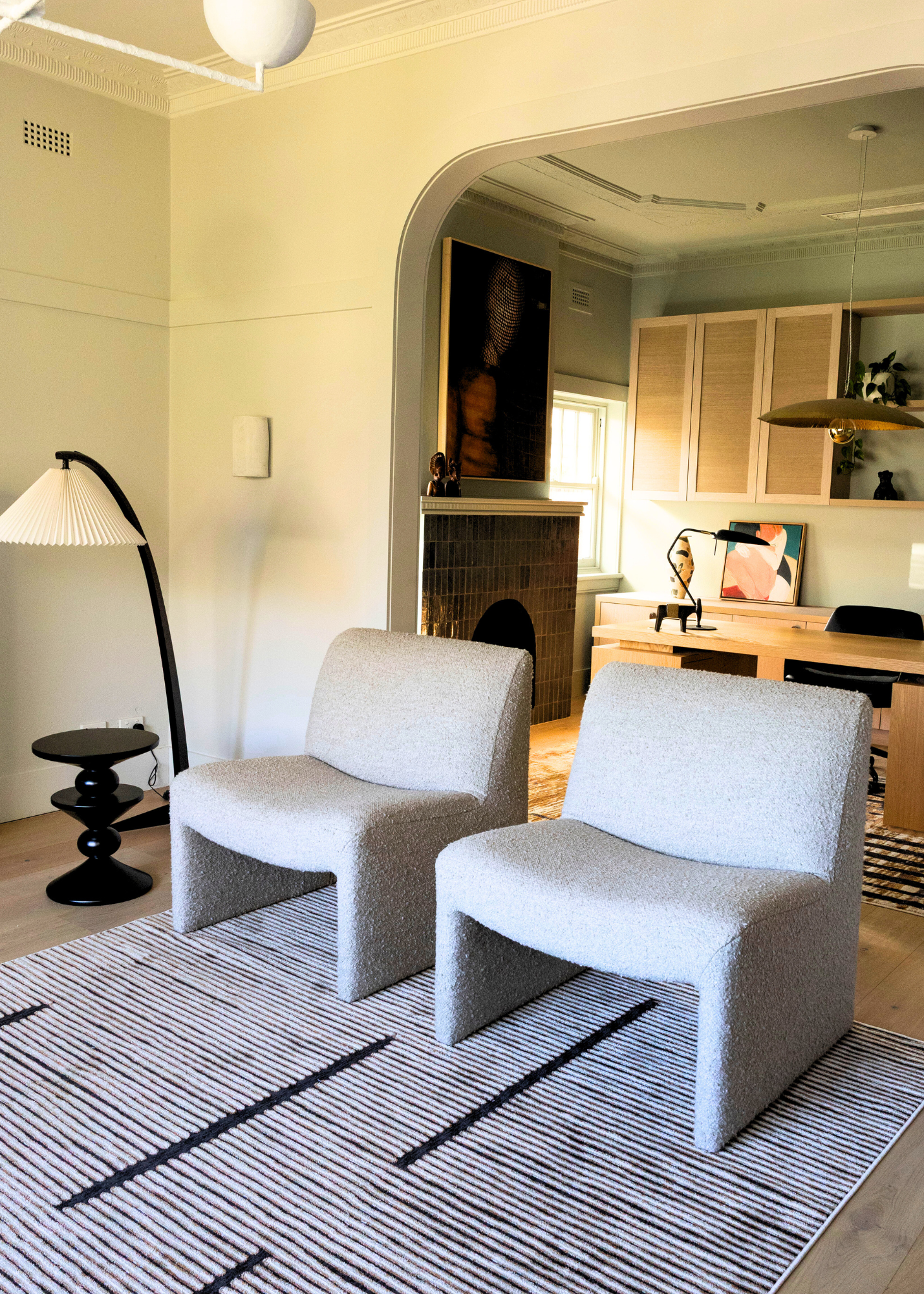 Modern living room with two grey chairs on Midnight Suede Abstract Rug by Four Corners Rugs, lamp, and home office in the background.