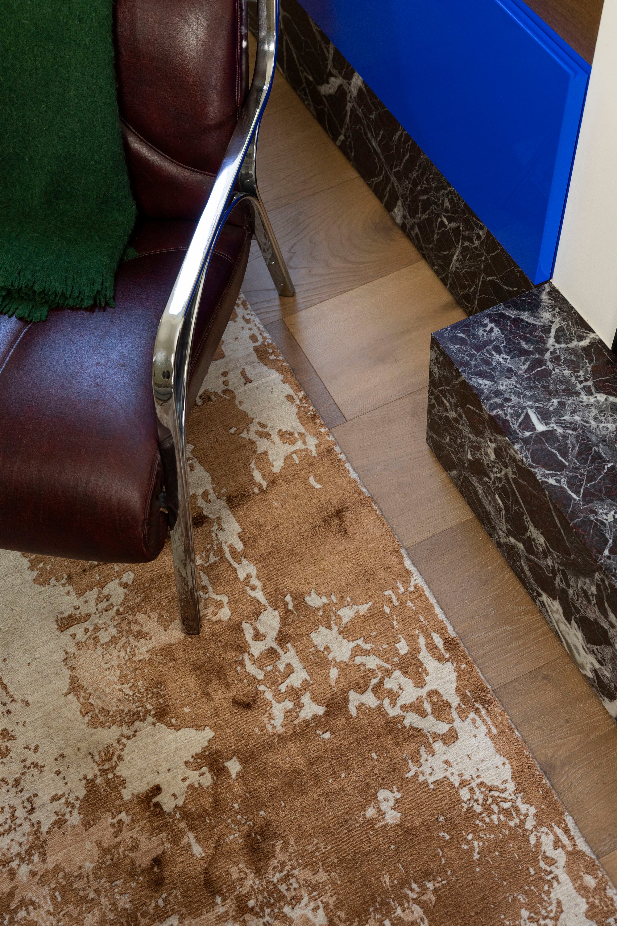 Brown leather chair on Blush Shadow Pink and Rust Rug By Four Corners Rugs