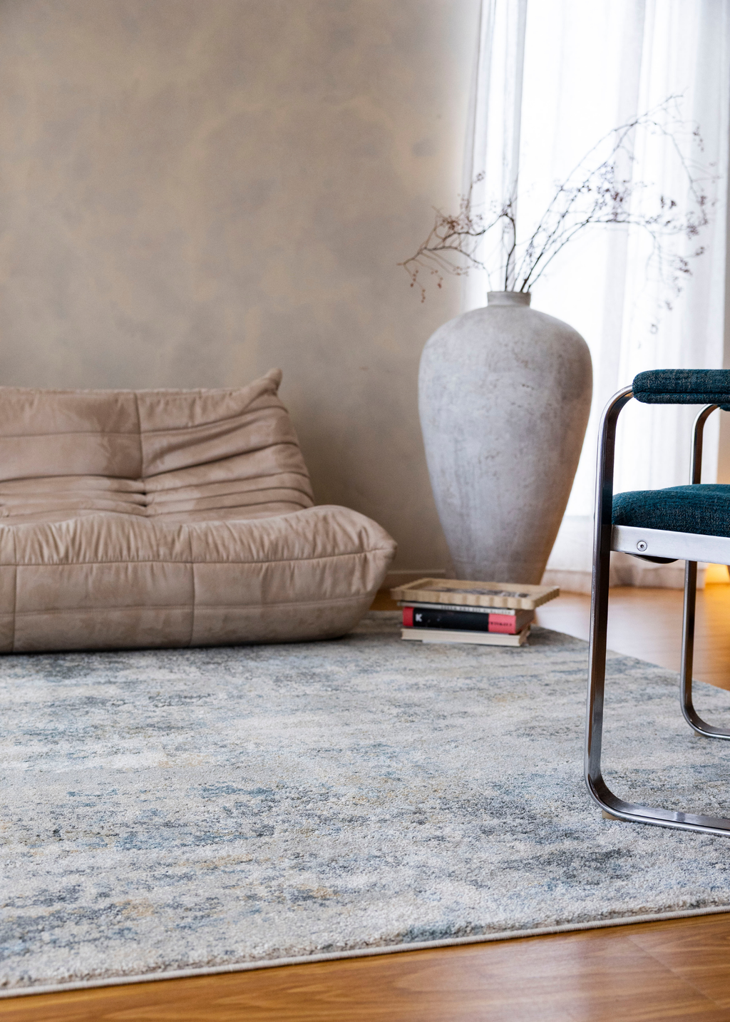 Living room with a beige sofa, Cooper Plush Rug by Four Corners Rugs, and large vase.