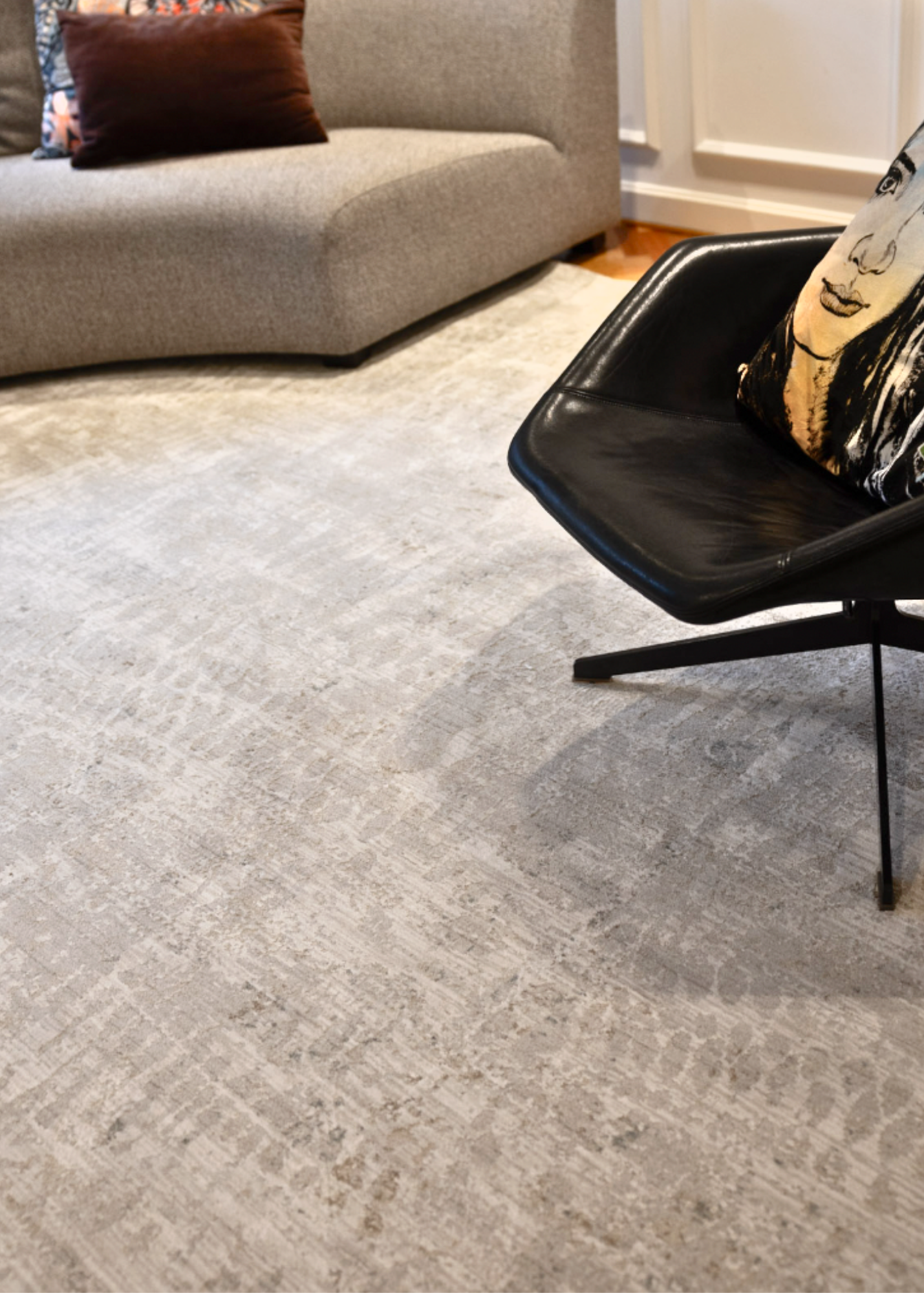 Fossil Beige and Grey Rug by Four Corners Rugs in a room with a chair and sofa.