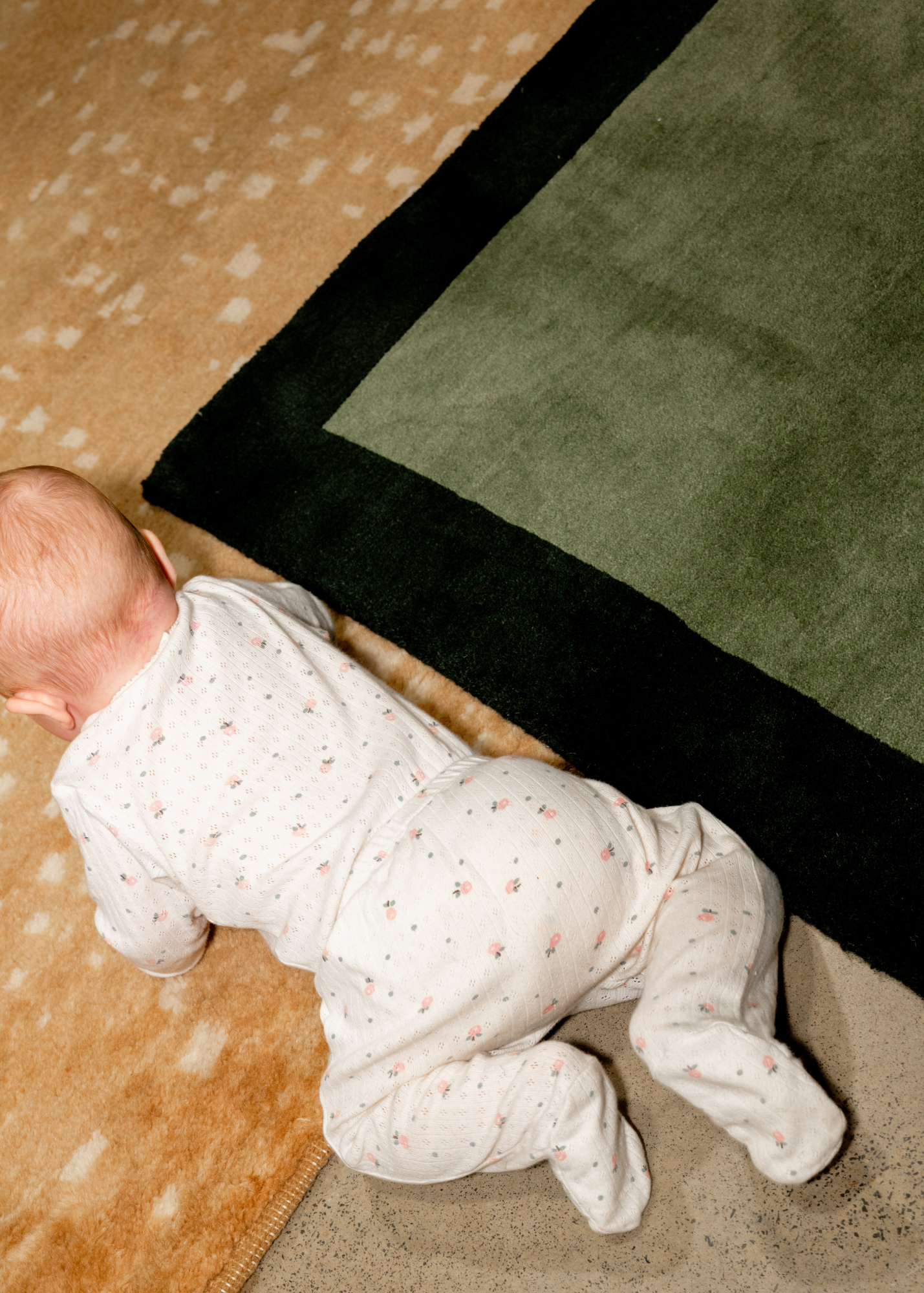 baby on Green and Green Border Rug by Four Corners Rugs