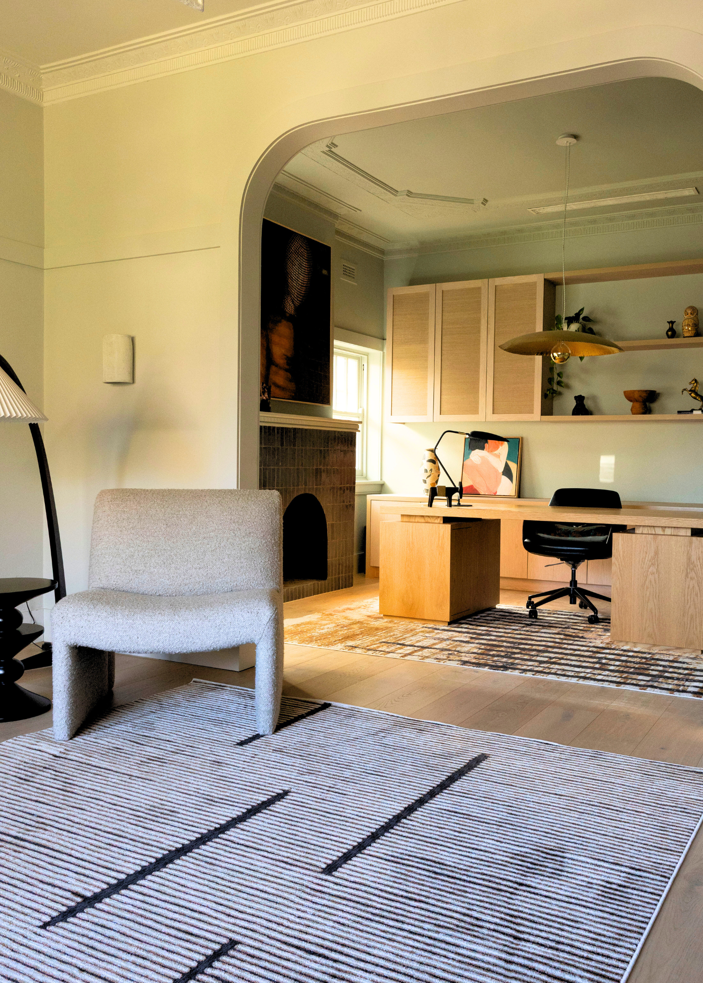 Living room with a chair, Midnight Suede Abstract Rug by Four Corners Rugs, and a view into a home office.