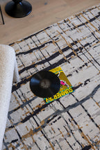 Vinyl record and cover on Moonlit Bloom Abstract Rug by Four Corners Rugs