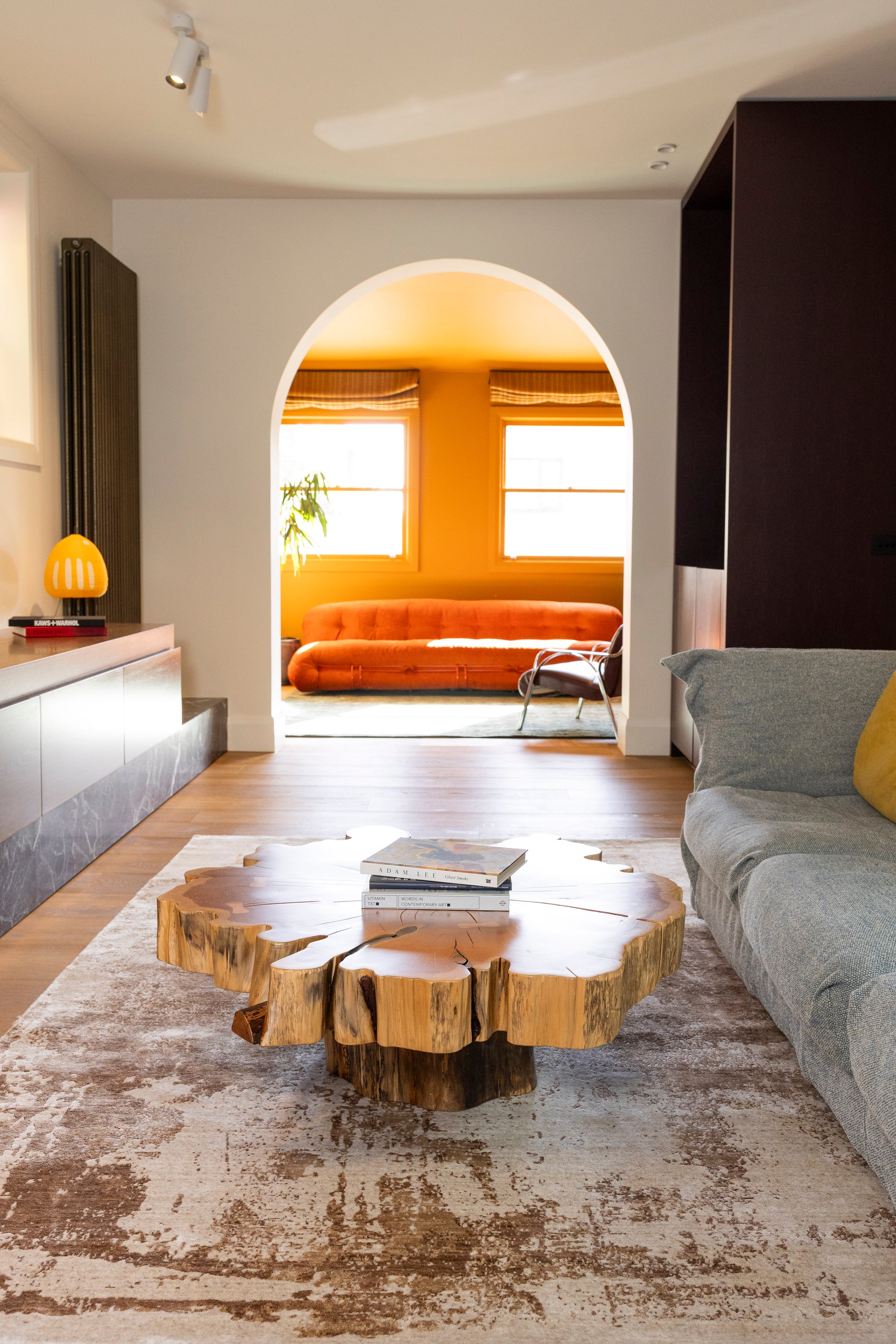 Modern living room with a wooden coffee table, grey sofa and Nude Contrast Gold and Brown Rug By Four Corners Rugs