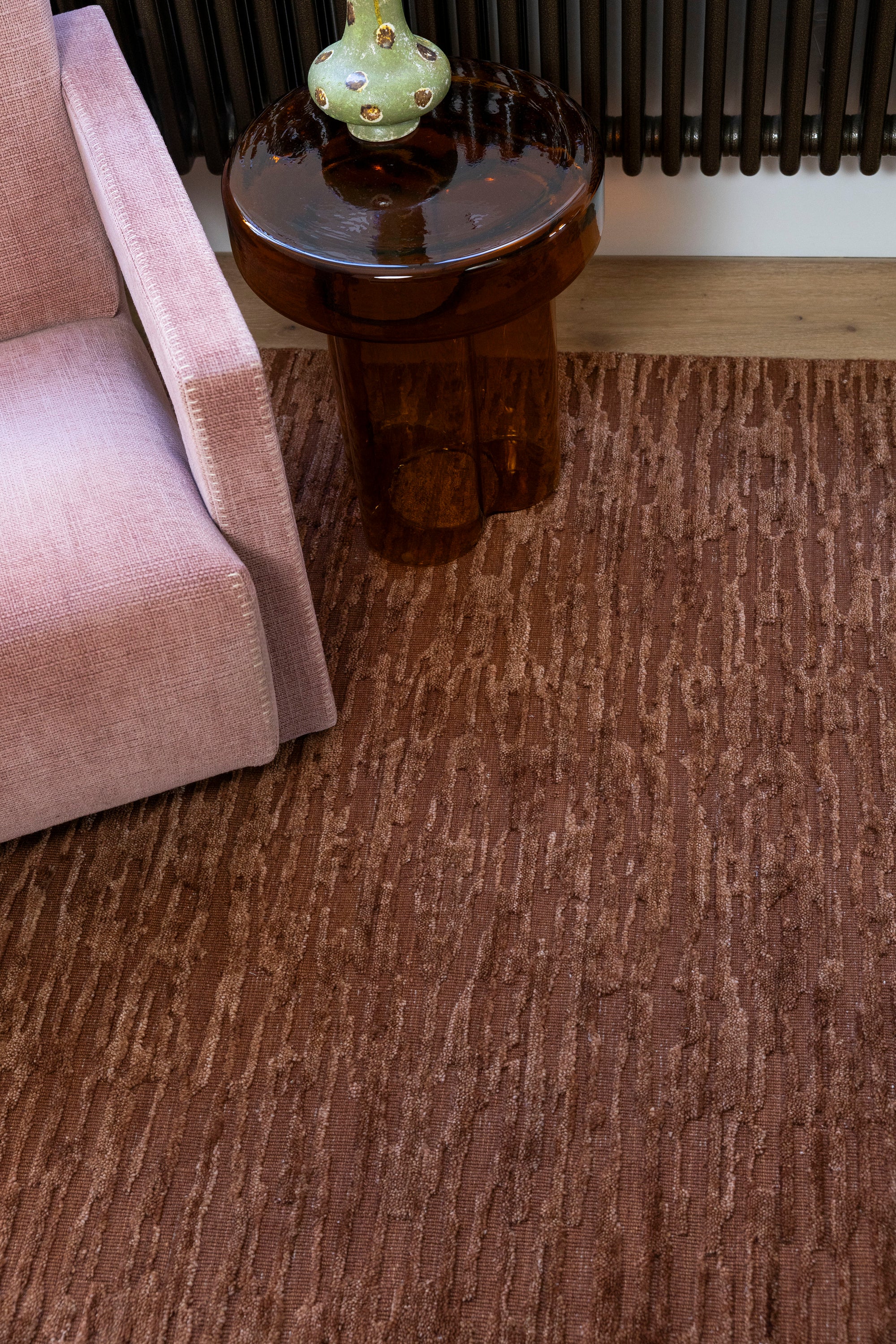 Oceana Rust by Four Corners Rugs with a side table and chair in the corner.