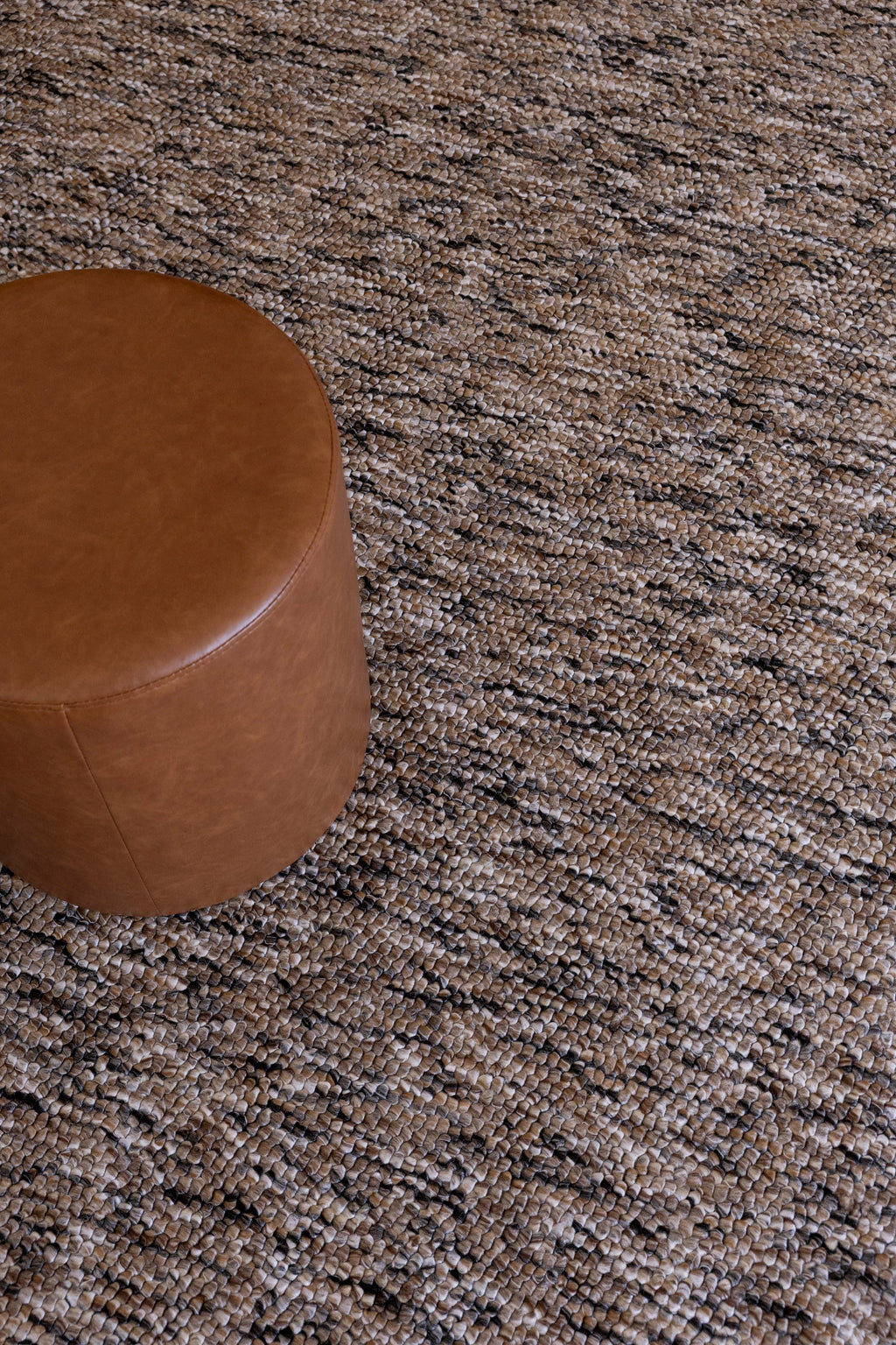 Brown leather ottoman on Pebbles Brown and Black by Four Corners Rugs