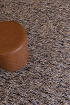 Brown leather ottoman on Pebbles Brown and Black by Four Corners Rugs