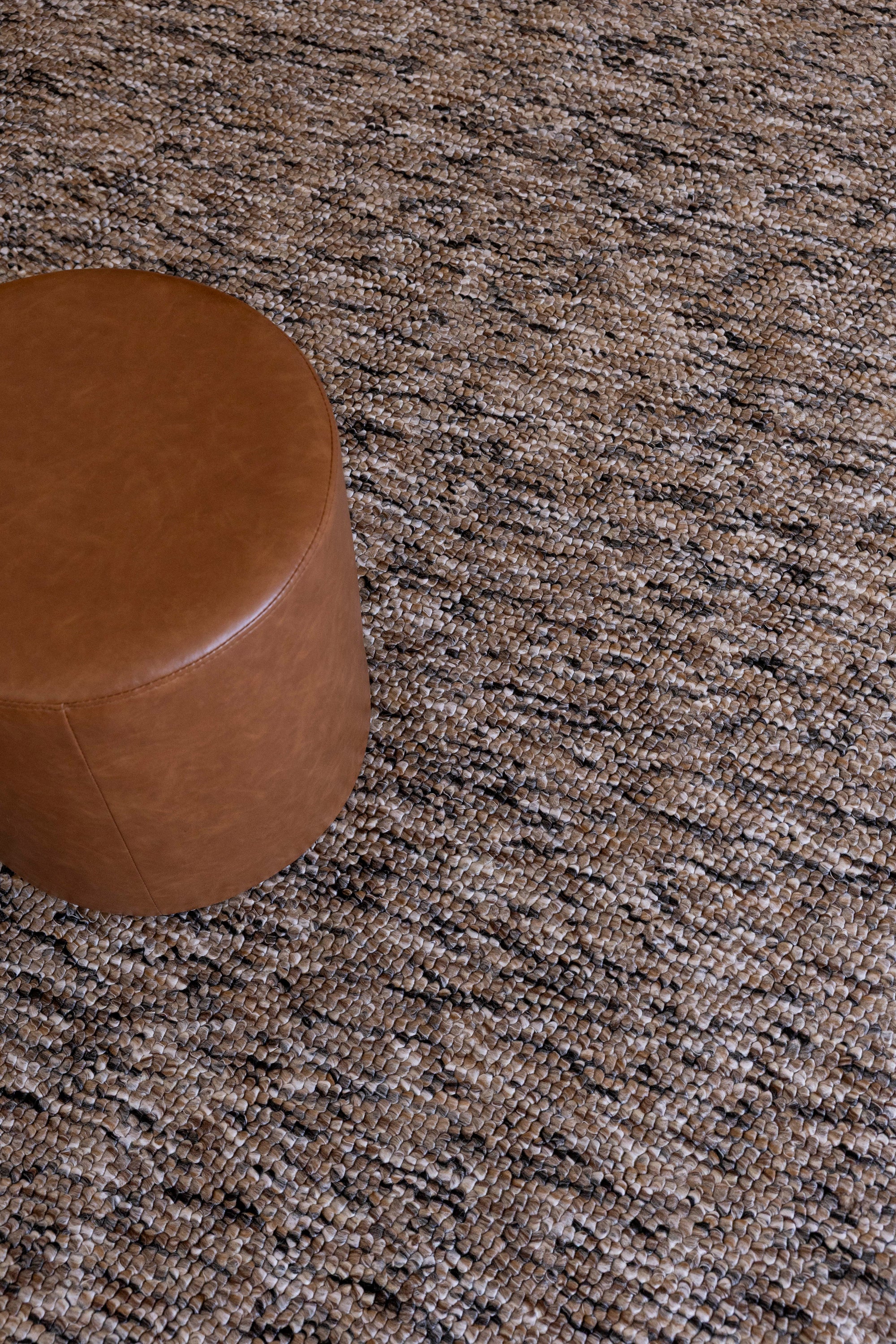 Brown leather ottoman on Pebbles Brown and Black by Four Corners Rugs