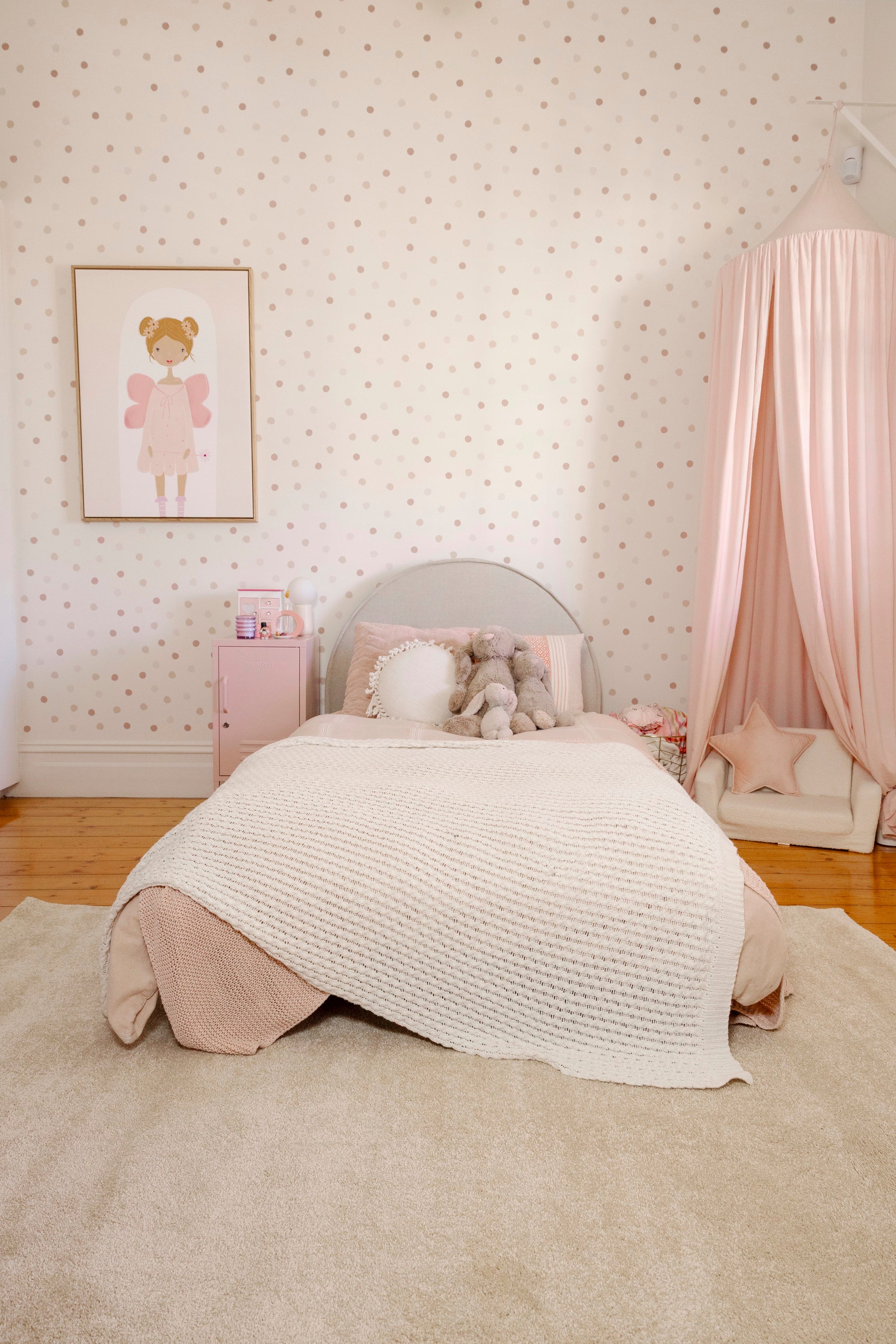 Children's bedroom with a bed, pink canopy and Plush Cream Rug by Four Corners Rugs