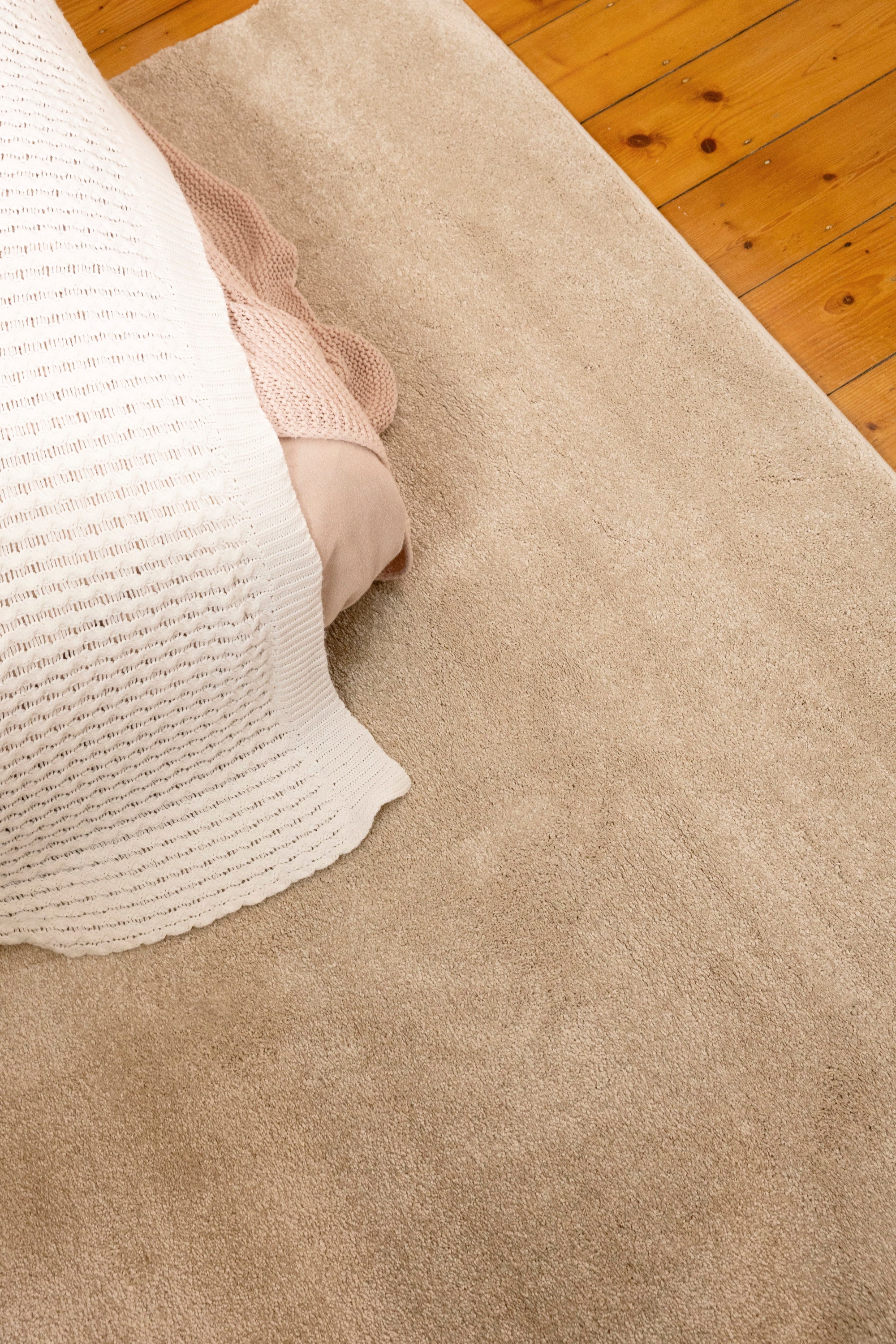 Plush Cream Rug by Four Corners Rugs close up in bedroom