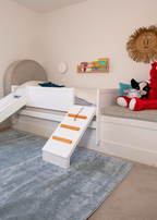 Children's bedroom with a bed, toys, and Plush Ice Blue Rug by Four Corners Rugs