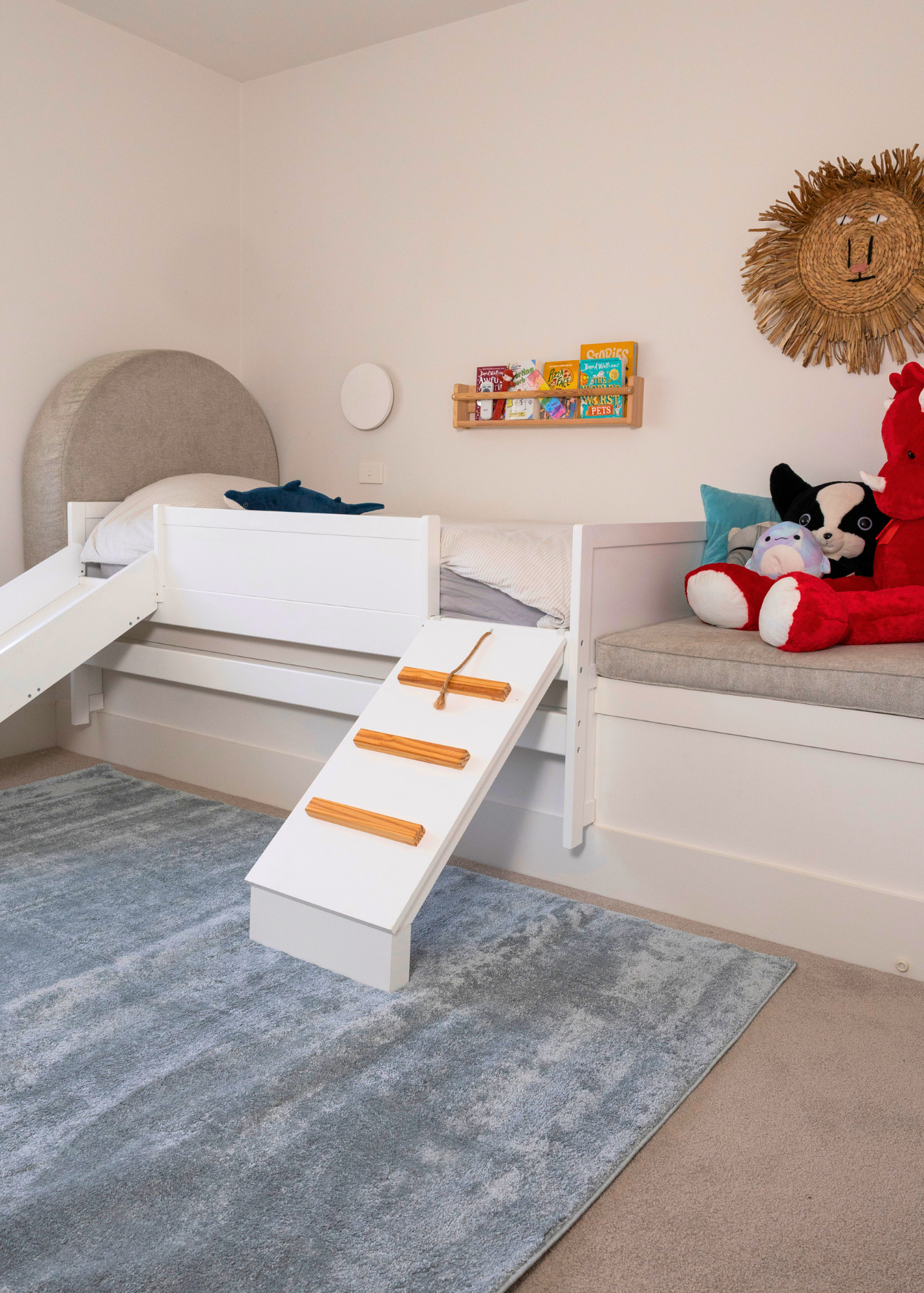 Children's bedroom with a bed, toys, and Plush Ice Blue Rug by Four Corners Rugs