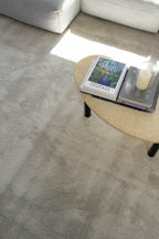 Concrete table in living room on Plush Light Grey Rug by Four Corners Rugs