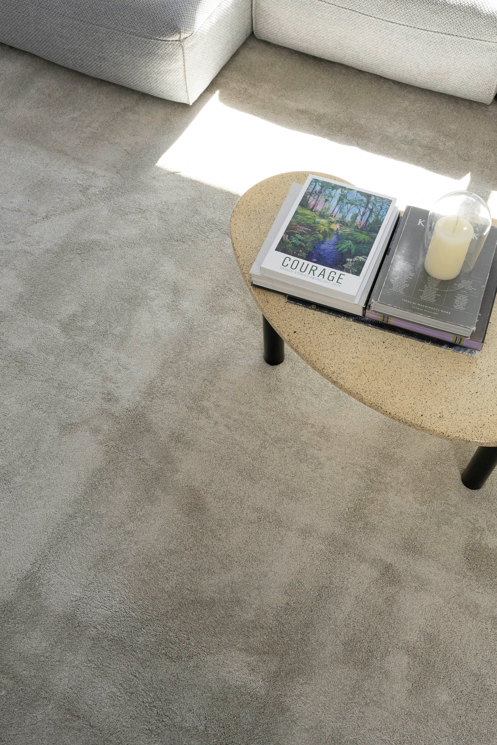 Concrete table in living room on Plush Light Grey Rug by Four Corners Rugs