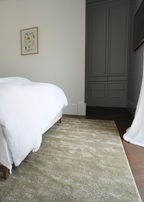 Bedroom with a bed, Plush Olive Green rug by Four Corners Rugs, and wardrobe.