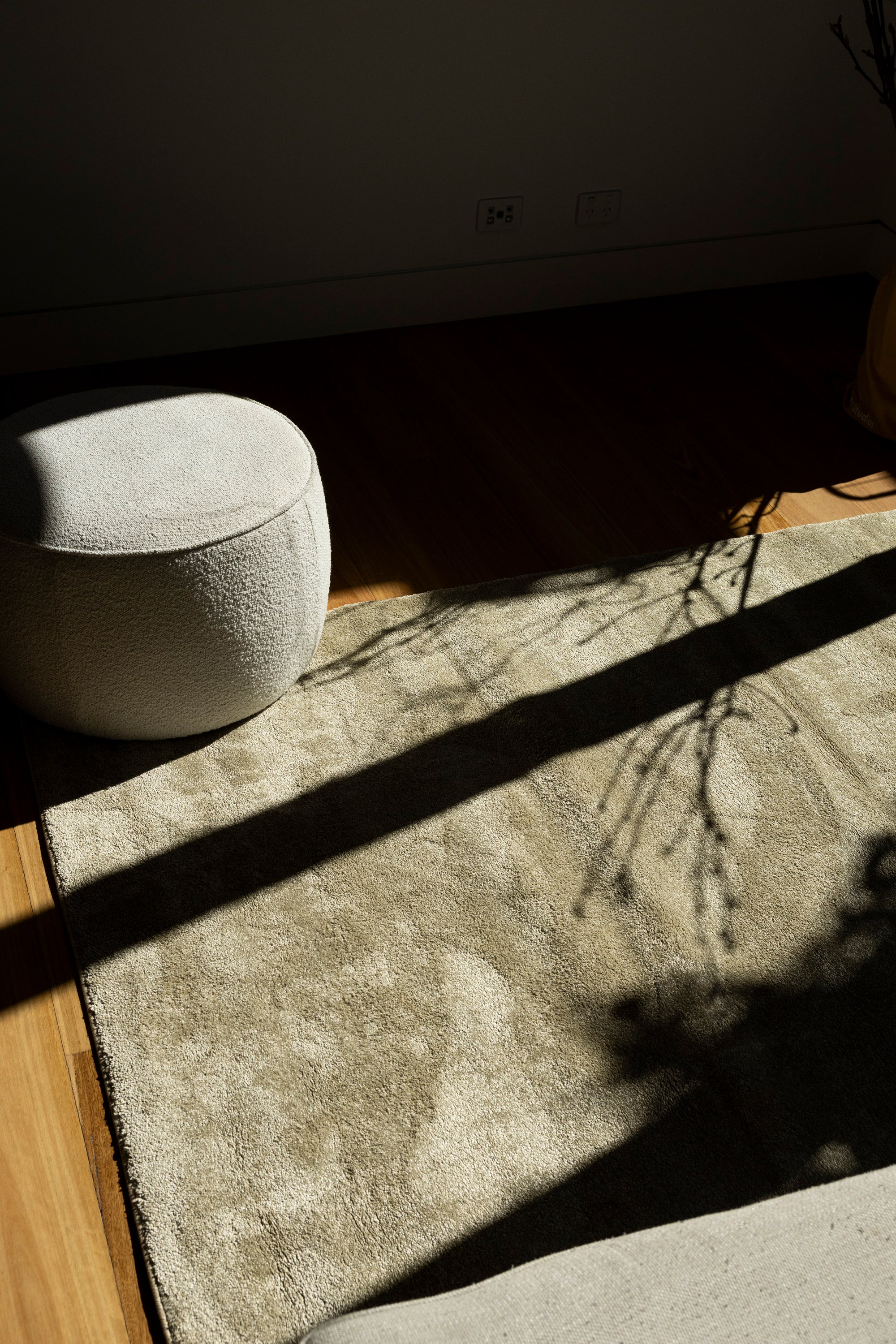 Ottoman on Plush Olive Green Rug by Four Corners Rugs