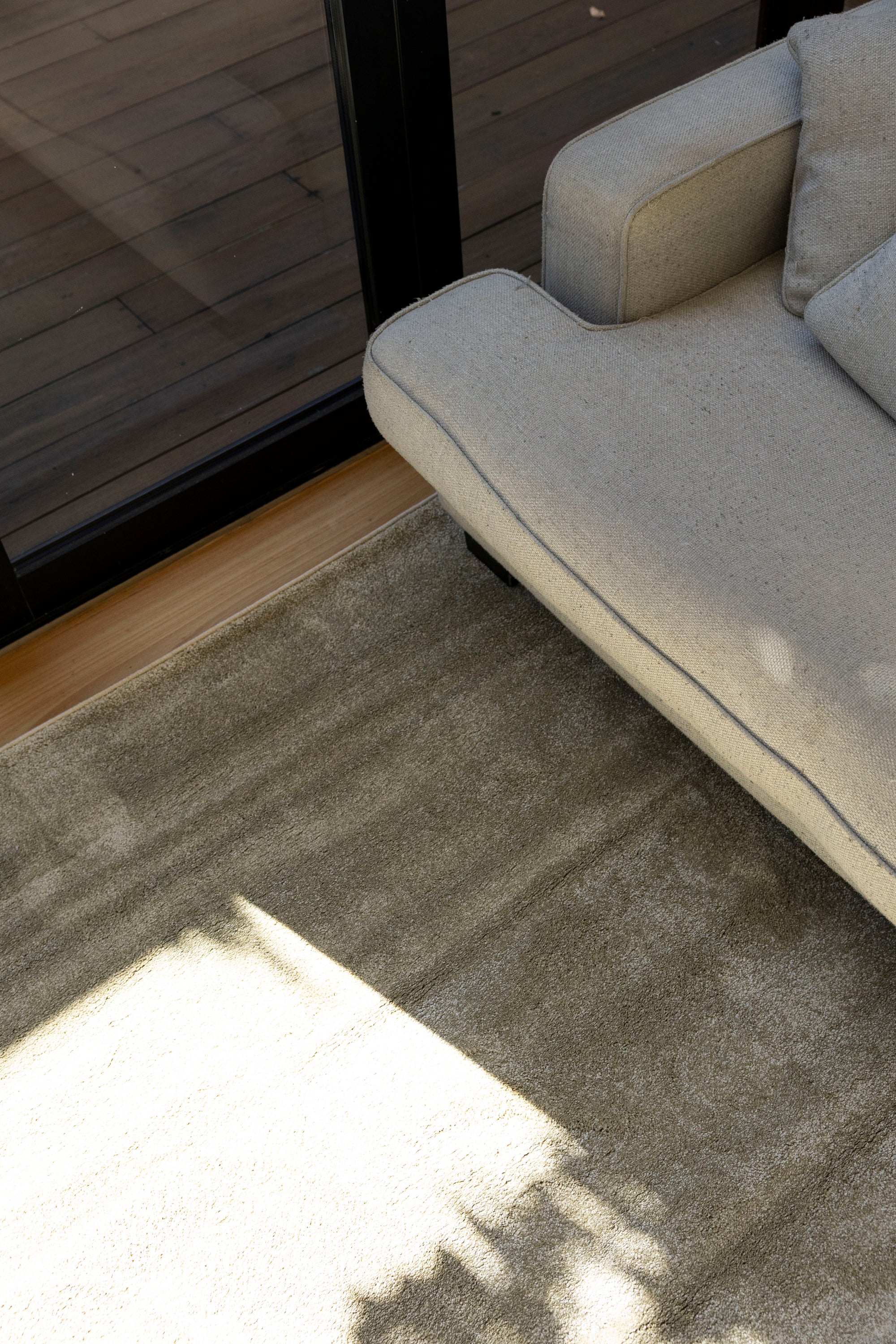 Gray sofa on Plush Olive Green Rug by Four Corners Rugs