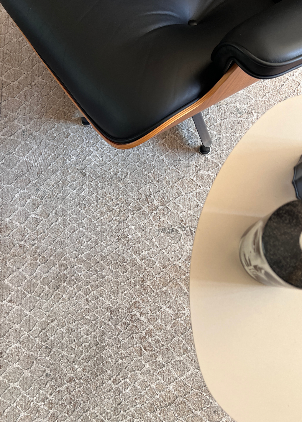 Close-up of a black office chair on Python Natural Base Rug by Four Corners Rugs