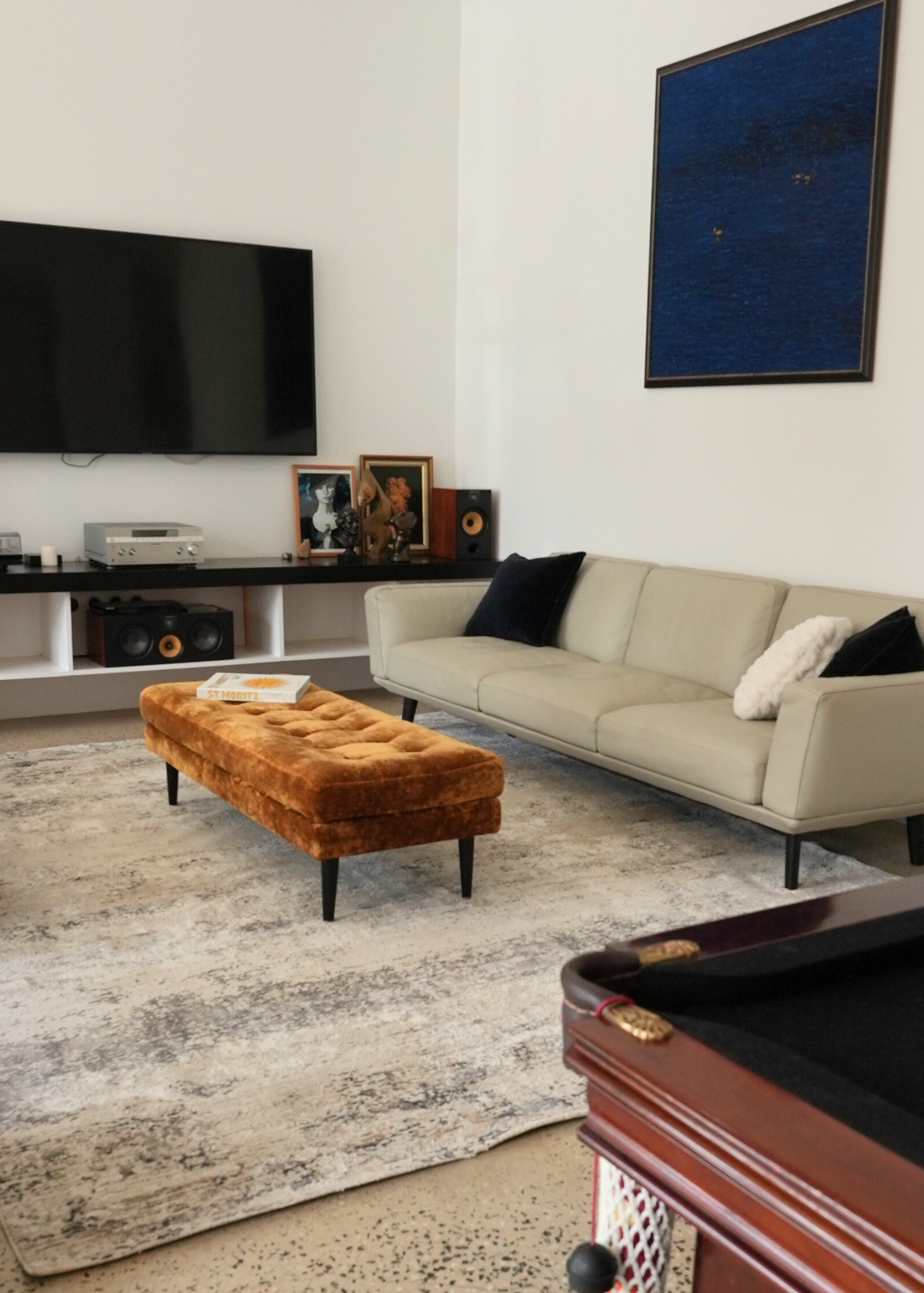 Living room with beige sofa, gold ottoman, and Silver Mist by Four Corners Rugs 