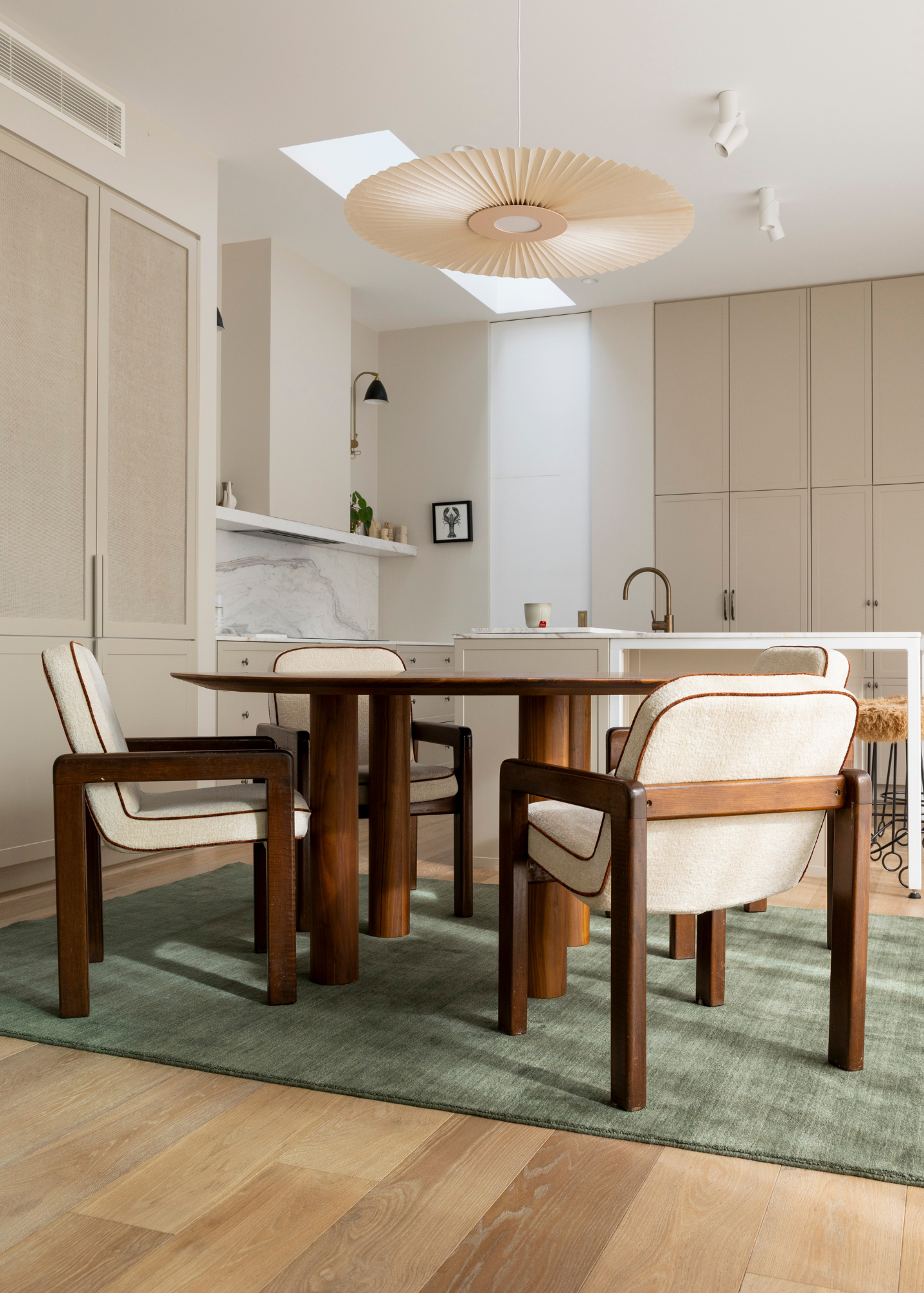 Modern kitchen with wooden dining table and chairs on Wool Texture Green Rug